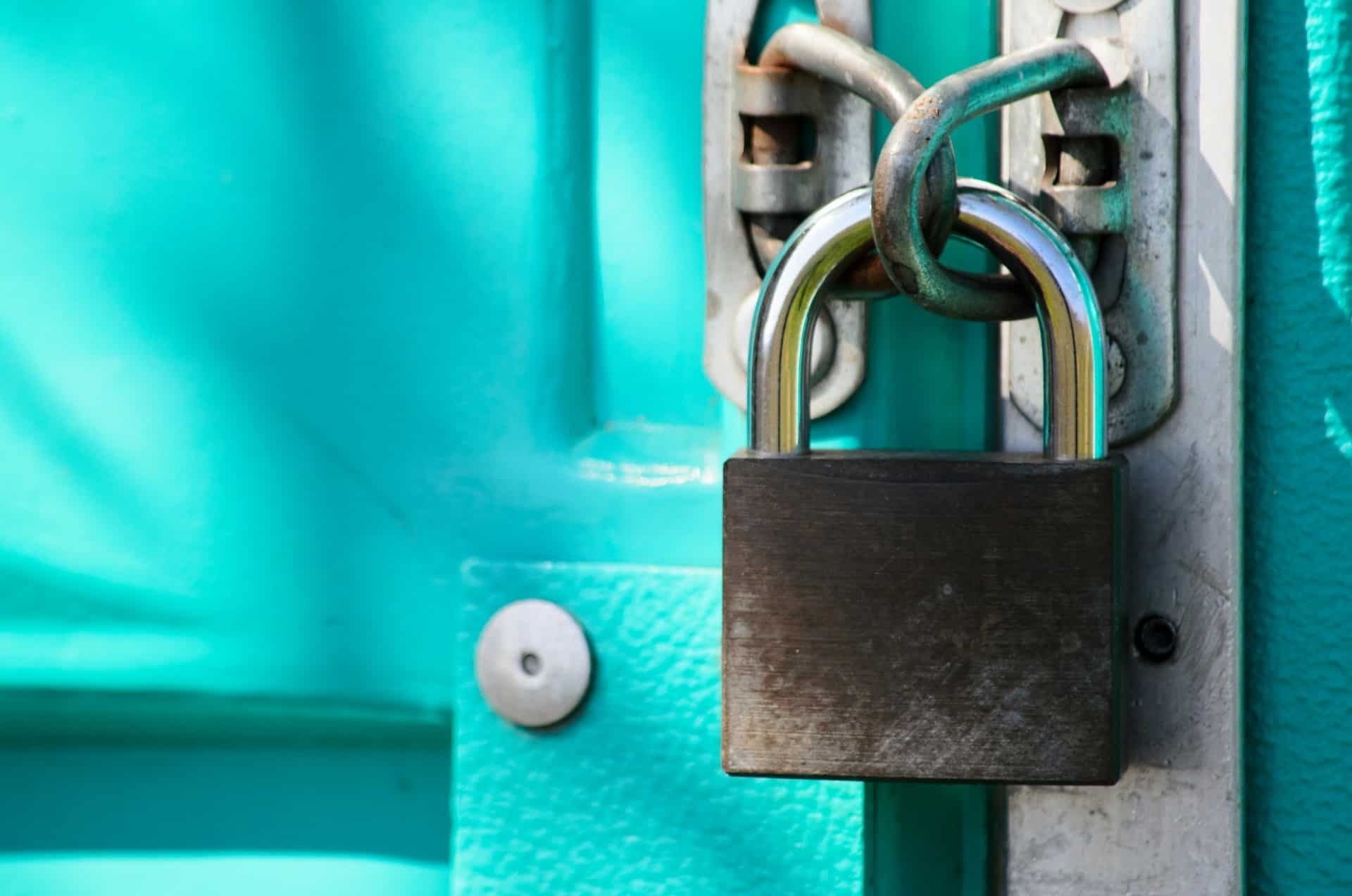 A sturdy padlock secures a teal door, symbolizing safety, privacy, and GDPR compliance.
