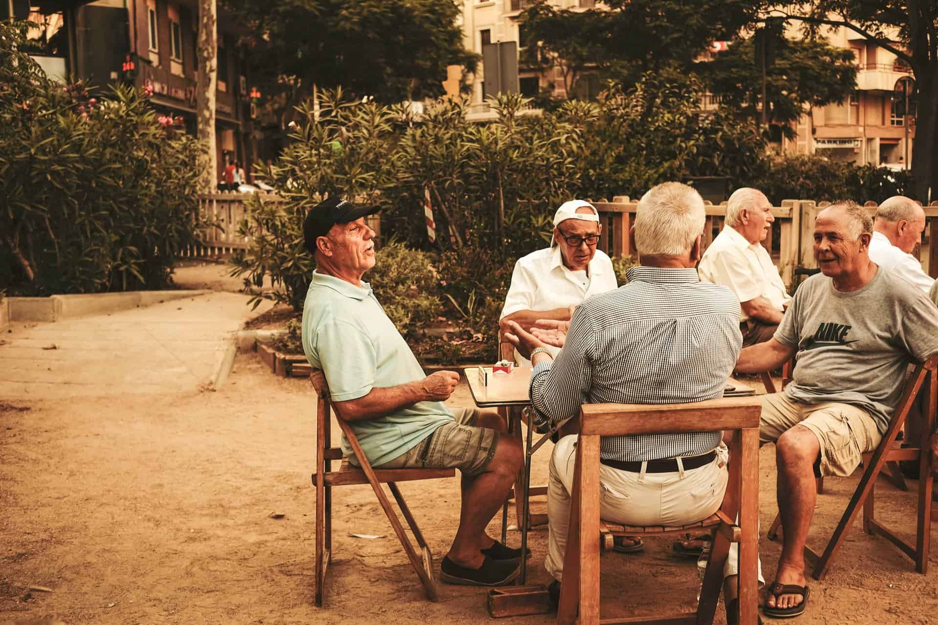 Elderly men sitting down together and socialising