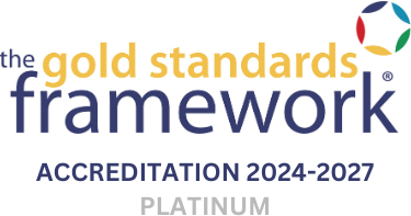 Logo for The Gold Standards Framework Accreditation 2024-2027, featuring the text in yellow and blue, with the word "PLATINUM" beneath and a multicolored circle design on the upper right.